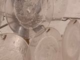 a lot of glasses that are hanging on a rack
