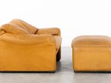 an image of a brown leather couch and ottoman in a room