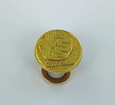 a gold bit coin sitting on top of a white surface