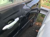 a car that has been damaged and is parked in the driveway