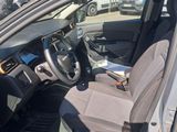 the interior of a car with the door open and the driver ' s seat down
