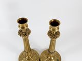 pair of antique brass candlesticks on a white background