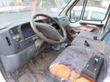 a car with a steering wheel and a laptop in the passenger seat