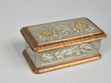 a silver and gold box sitting on a white surface