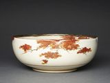 bowl decorated with maple leaves on a white background