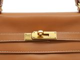 a close up of a brown leather handbag on a white background