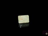 an image of a piece of green jade on a black surface