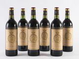 six bottles of wine are lined up in a row on a white surface