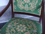 a green chair with a floral pattern on it