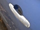 a close up of a door handle on a blue car