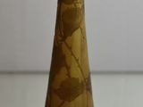 a glass bottle with a brown liquid inside of it
