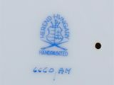 a close up of a plate with a blue and white design on it