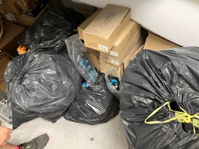 many bags of trash in the back of a truck