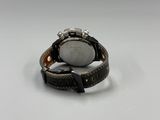 a close up of a watch on a white surface with a white background