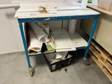 an image of a workbench with a lot of papers on it