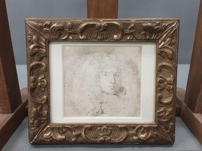 an old picture frame with a drawing of a man ' s face