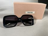 a close up of a pair of black sunglasses on a table
