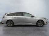 the silver car is parked in a parking lot on a cloudy day