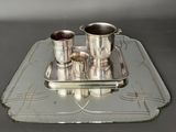 a tray with silver cups and a tray with silver cups on it