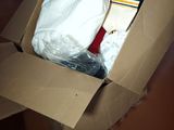 a cardboard box filled with clothes and a pair of shoes