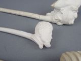 two pipe heads and a pipe holder on a table
