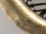close up of a brass plate with a curved handle