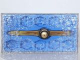a blue box with a watch on it on a table