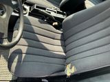 a picture of the inside of a car with a gun on the steering wheel