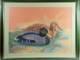 painting of two ducks sitting on the water in a green frame