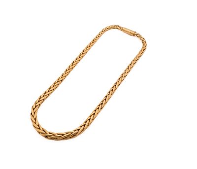 a gold necklace with a chain on a white background