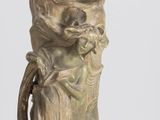a statue of a woman holding a flower in a vase