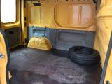 a yellow van with a tire in the back of it