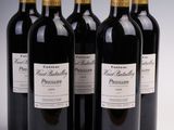 six bottles of red wine are lined up in a row