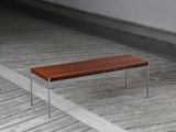 a wooden bench sitting on a wooden floor in a room