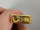 a person holding a piece of gold in their hand