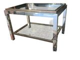 mirrored coffee table with metal legs and a glass top