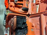 a orange case with tools inside of it on the floor