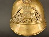 a gold helmet with a coat of arms on it