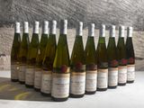 several bottles of wine are lined up in a row on a table