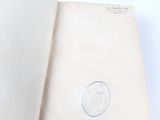 an open book with a stamp on it sitting on a table