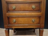 an image of a wooden chest of drawers with brass knobs