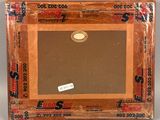 an old picture frame with a sticker on it sitting on a table
