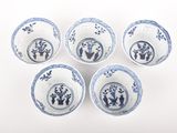 six blue and white bowls with designs on them on a white surface