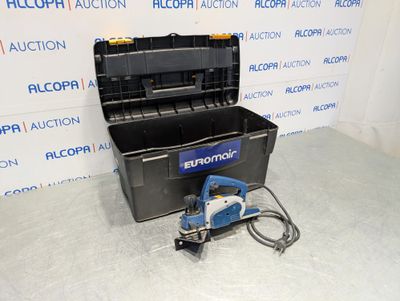 an image of a tool box with a power tool on the floor