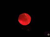 a red apple that is glowing in the dark