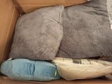 a box full of blankets and pillows in it