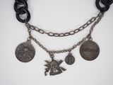 an image of a necklace with coins and charms attached to it