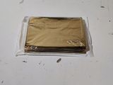 a bag of gold foil sitting on a white table