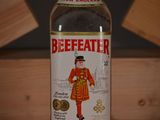 a bottle of beefeater sitting on a wooden table