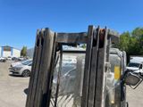 a close up of a forklift parked in a parking lot